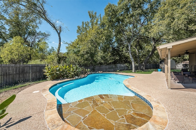 view of pool with a patio and ceiling fan