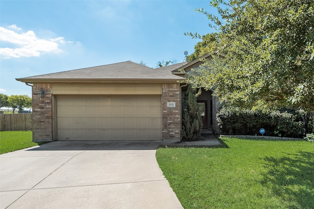 view of front of house with a garage and a front lawn