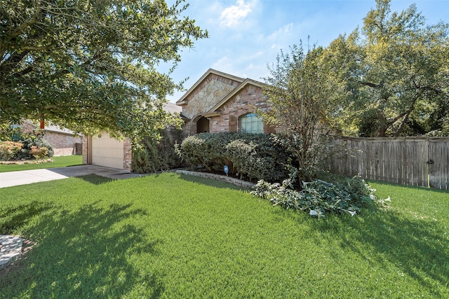 obstructed view of property with a garage and a front lawn