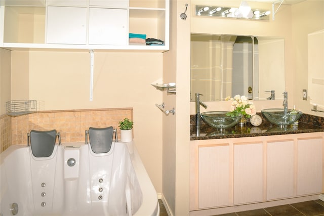 bathroom with vanity, a bathing tub, tasteful backsplash, and tile patterned floors