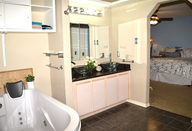 bathroom featuring vanity, tile patterned floors, ceiling fan, and a washtub