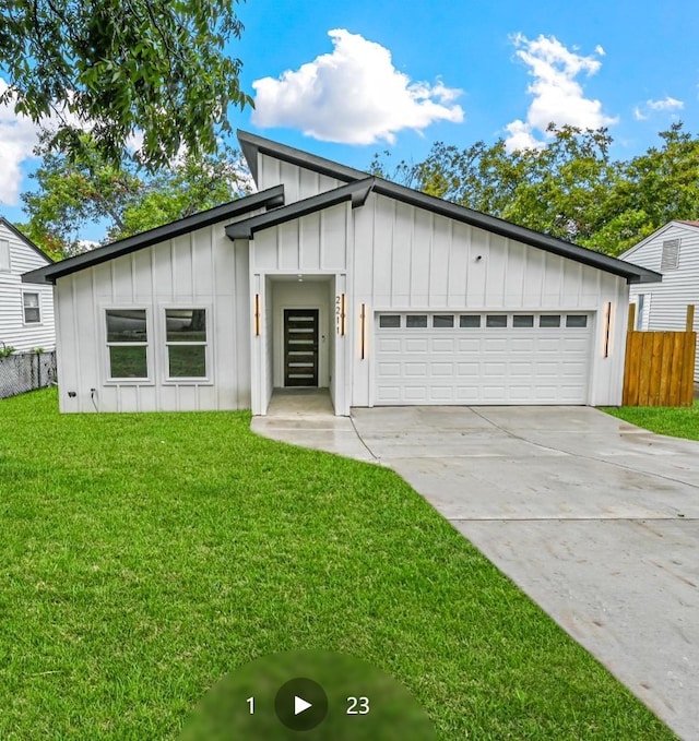 modern farmhouse style home featuring a front lawn and a garage