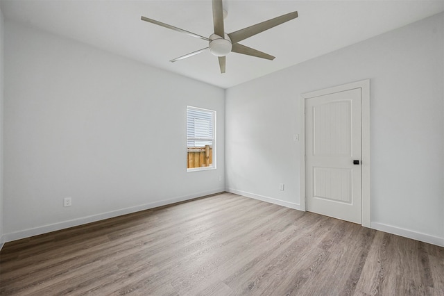 spare room featuring ceiling fan and light hardwood / wood-style flooring