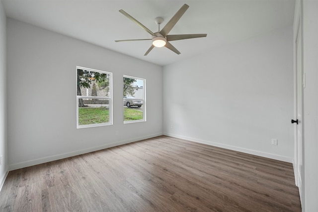 empty room with ceiling fan and hardwood / wood-style flooring