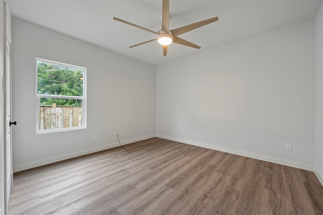 unfurnished room with light wood-type flooring and ceiling fan