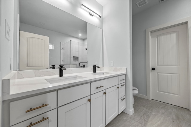 bathroom featuring walk in shower, vanity, and toilet