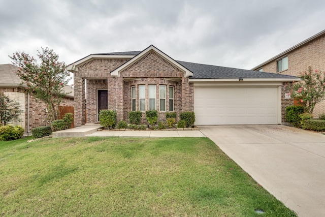 view of front of property featuring a front yard and a garage