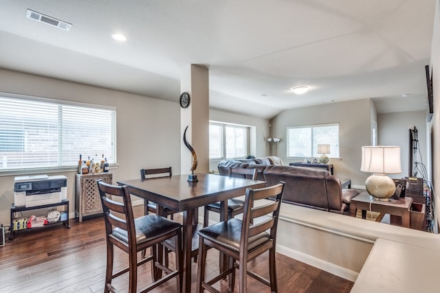 dining area with lofted ceiling and dark wood-type flooring