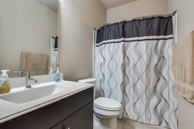 bathroom featuring tile patterned floors, walk in shower, vanity, and toilet