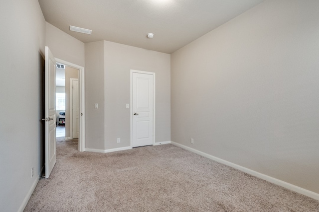 unfurnished bedroom with light carpet