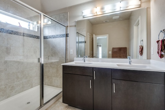 bathroom featuring vanity, tile patterned flooring, and an enclosed shower