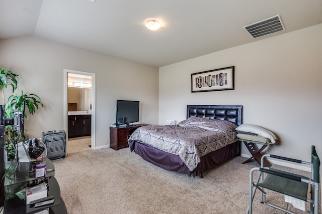 carpeted bedroom with connected bathroom and lofted ceiling