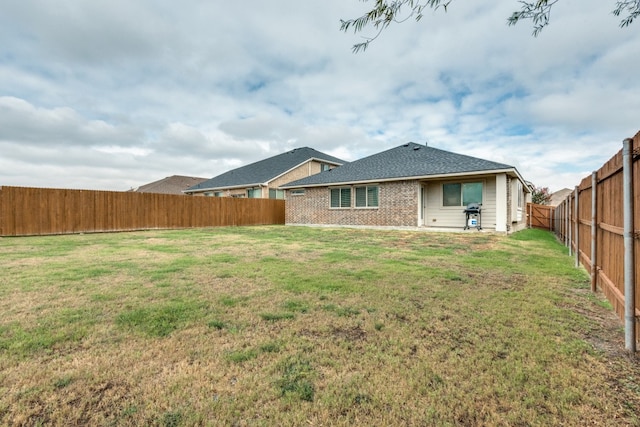 back of property featuring a yard