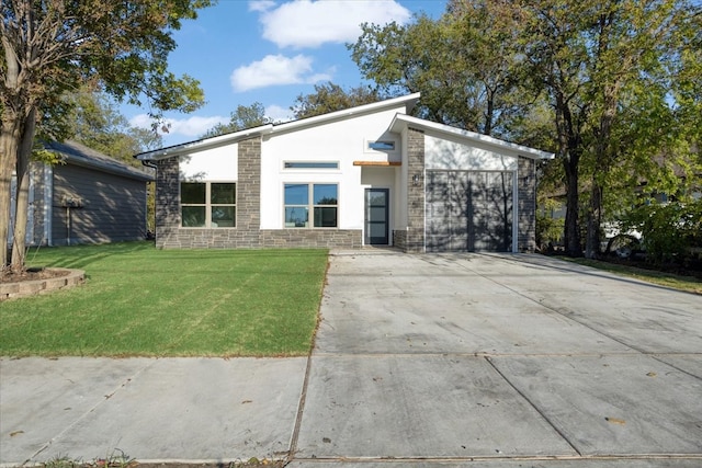 contemporary home with a front yard and a garage