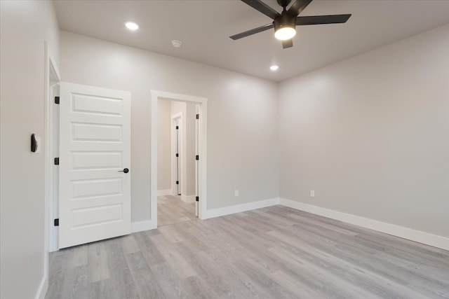 empty room with light wood-type flooring and ceiling fan