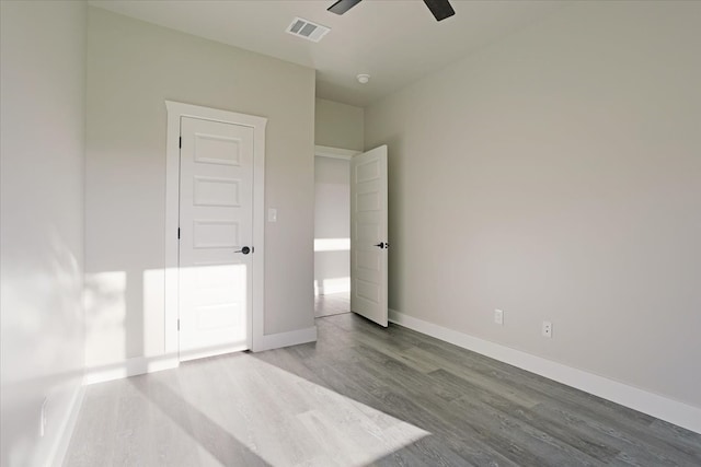 unfurnished bedroom with ceiling fan and wood-type flooring