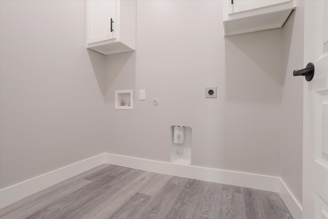 laundry room with cabinets, light wood-type flooring, gas dryer hookup, hookup for a washing machine, and electric dryer hookup