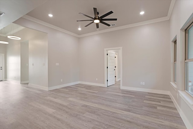 spare room featuring ceiling fan, crown molding, and light wood-type flooring