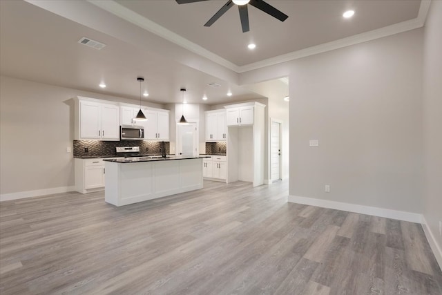 kitchen with light hardwood / wood-style flooring, white cabinets, hanging light fixtures, and a kitchen island