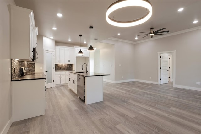 kitchen with sink, light hardwood / wood-style flooring, a center island with sink, and white cabinets