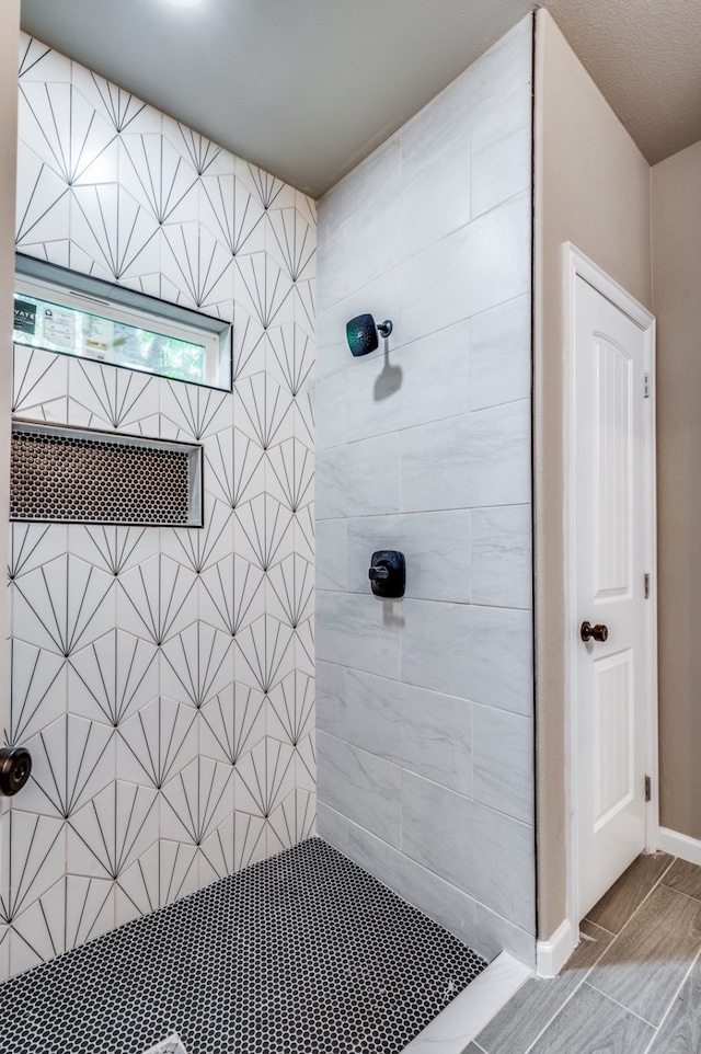 bathroom with tiled shower