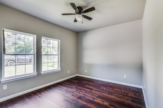 unfurnished room with dark wood-type flooring and ceiling fan