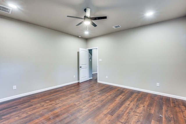 spare room featuring ceiling fan and dark hardwood / wood-style flooring