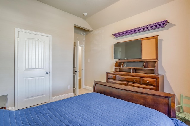 carpeted bedroom with lofted ceiling