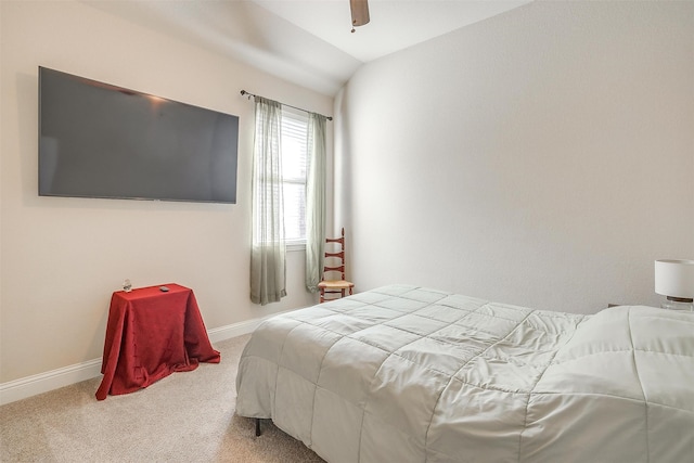 carpeted bedroom with vaulted ceiling and ceiling fan