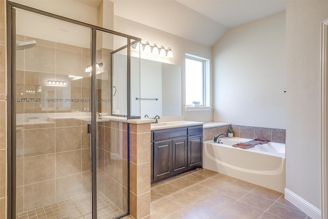 bathroom featuring vanity, separate shower and tub, vaulted ceiling, and tile patterned floors