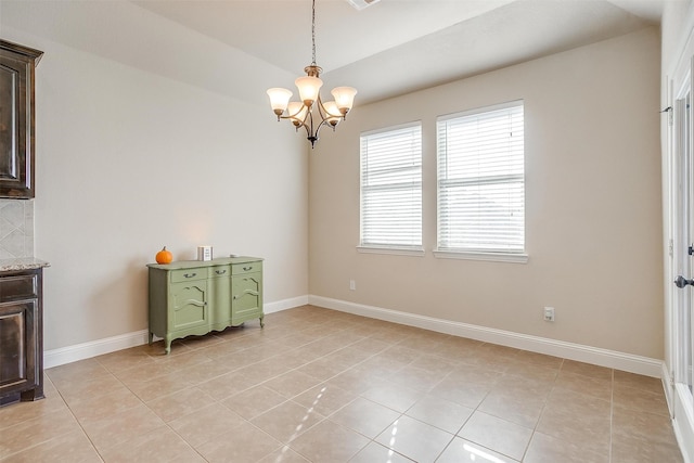 tiled dining space with a chandelier