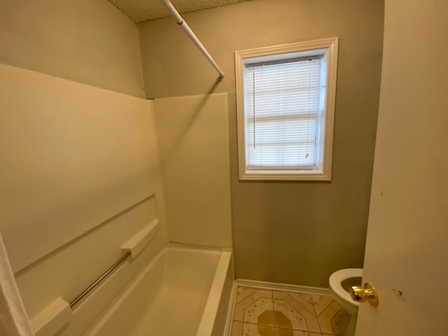 bathroom featuring shower / bath combination, toilet, and tile patterned floors