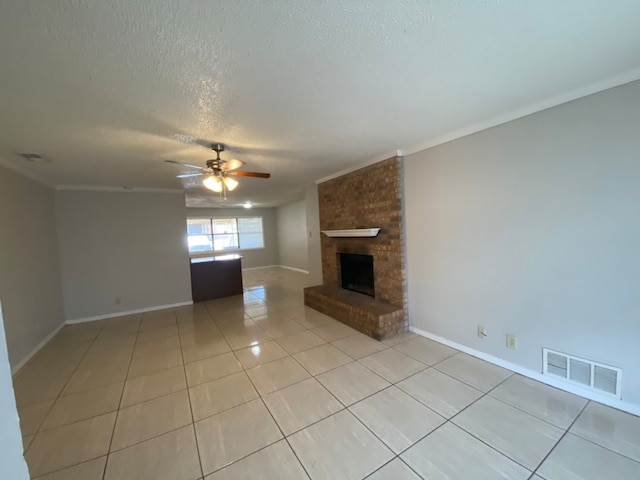 unfurnished living room with light tile patterned floors, ornamental molding, ceiling fan, and a fireplace