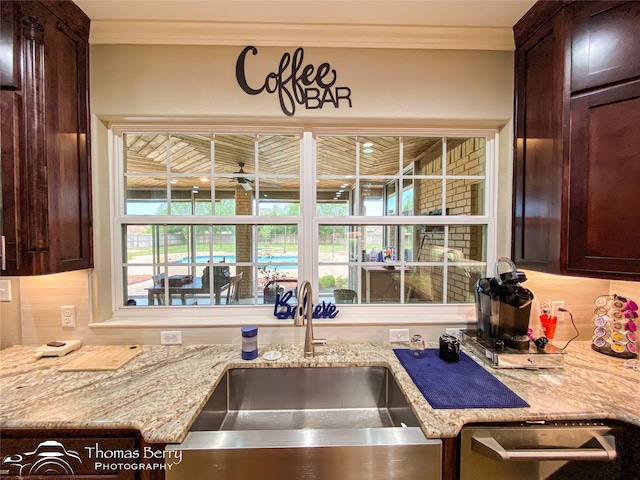 kitchen with crown molding, sink, decorative backsplash, and a healthy amount of sunlight