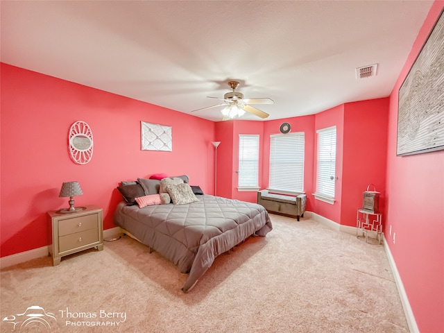 bedroom with ceiling fan and light colored carpet