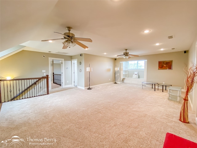 interior space featuring light carpet and ceiling fan