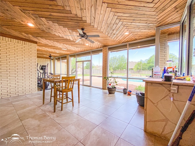 sunroom / solarium with wooden ceiling and ceiling fan