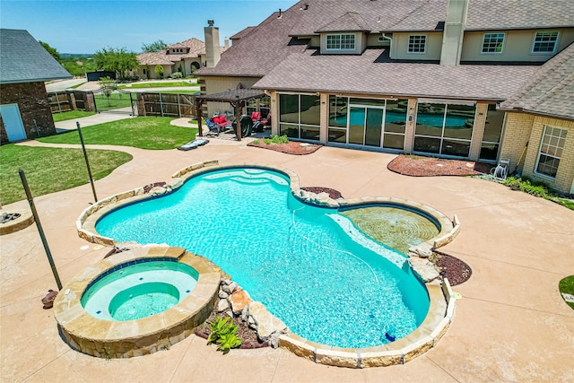 view of swimming pool featuring a patio, a yard, and an in ground hot tub