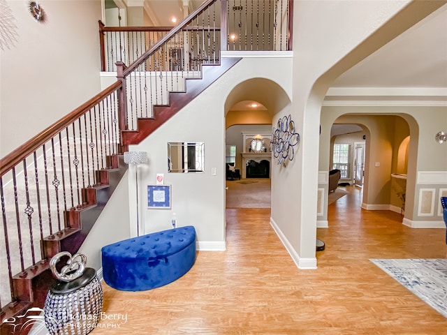 stairway featuring a towering ceiling and hardwood / wood-style floors