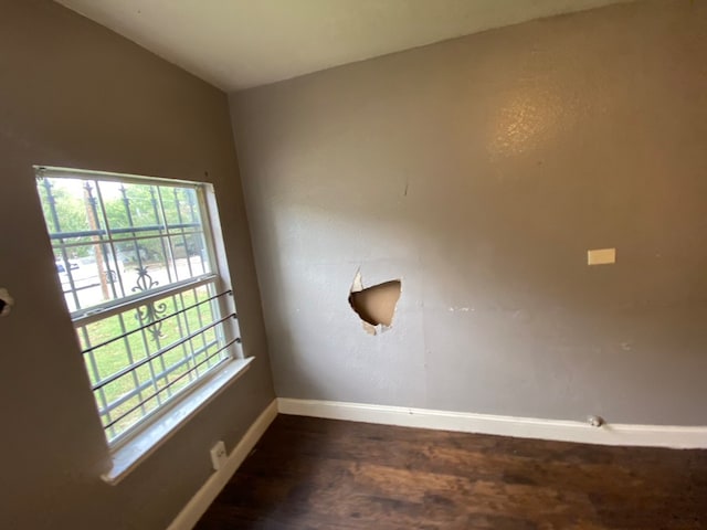 unfurnished room featuring dark wood-type flooring