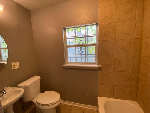 full bathroom featuring sink, shower with separate bathtub, toilet, and tile patterned floors