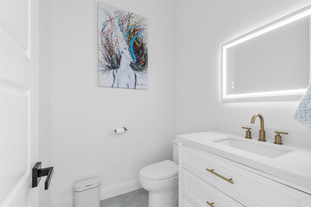 bathroom featuring tile patterned floors, vanity, and toilet