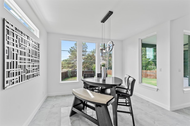 dining room featuring plenty of natural light and an inviting chandelier