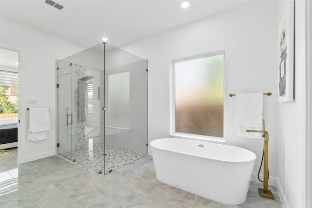 bathroom featuring radiator and shower with separate bathtub