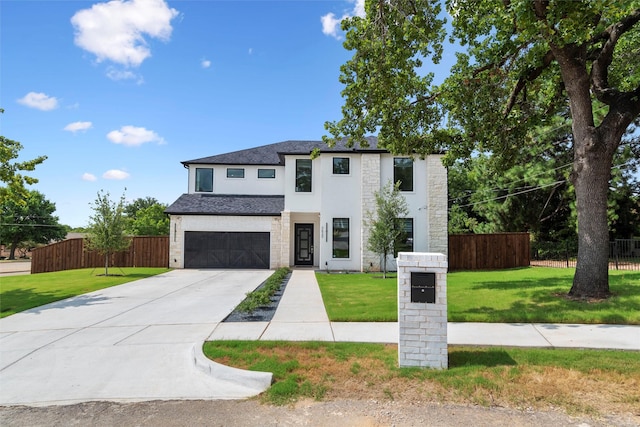 view of front of home with a front yard and a garage