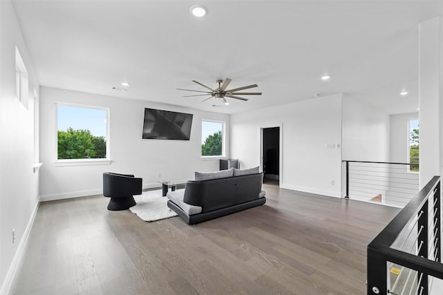 living room featuring hardwood / wood-style floors and ceiling fan