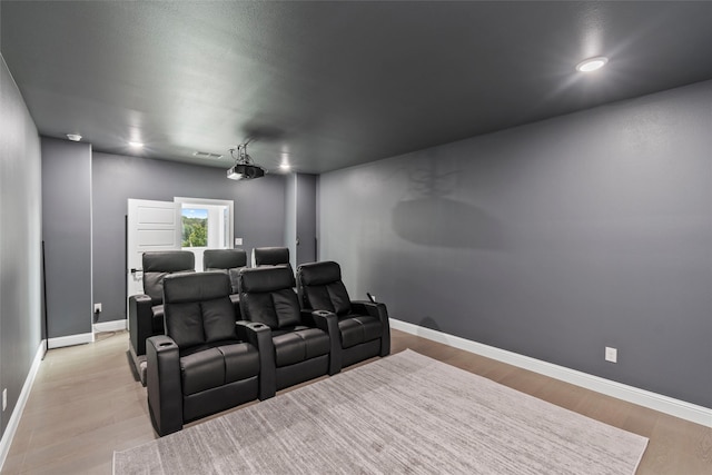 cinema room with light hardwood / wood-style flooring