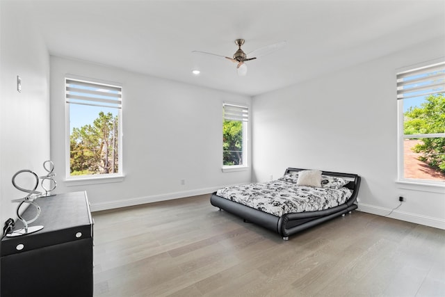 bedroom with light hardwood / wood-style flooring and ceiling fan