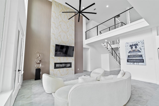 living room featuring a high ceiling and a premium fireplace