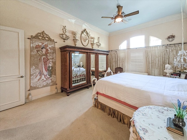 carpeted bedroom with ceiling fan and crown molding